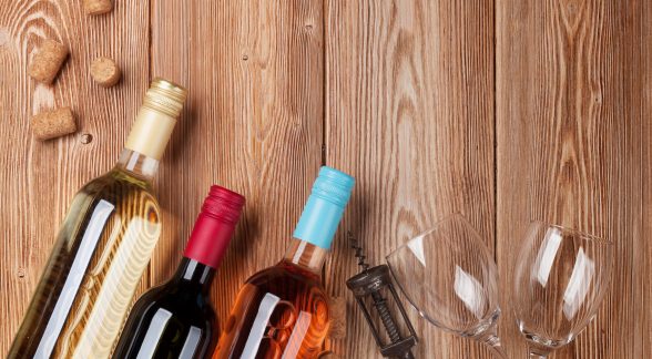 Wine bottles Wine bottles on wooden table. Red, rose and white wine. Top view with space for your text